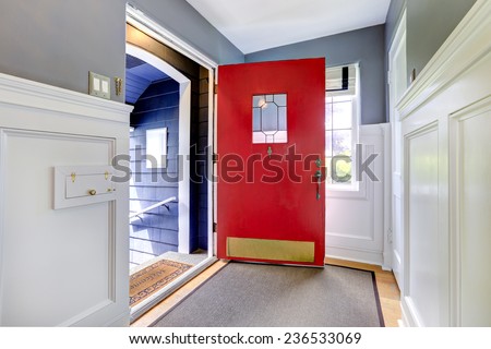 Entrance hallway with hardwood floor, white and grey walls and bright red door