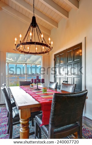 Dining room table with large iron chandelier.