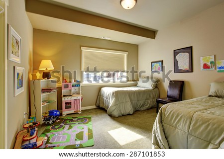 Kids bedroom with twin bed sets, a window and carpet.