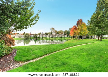 Beautiful backyard with water view and lots of grass.