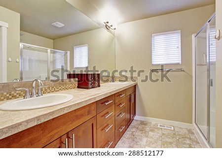 Elegant bathroom with tile floor, window, and glass shower.