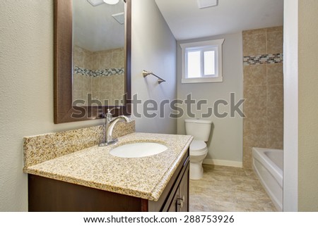 Medium sized bathroom with tile floor, full bath shower, and a window.