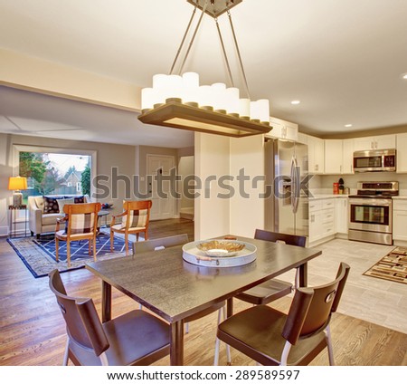 Elegant dinning room with connected kitchen and hardwood floor.