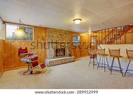 Authentic downstairs bar room with fireplace and carpet.
