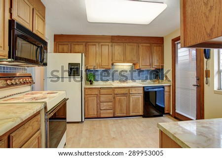 Simple kitchen with hardwood floor and a door.