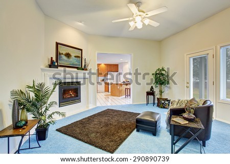 Gorgeous living room with bright blue carpet and nice decor.