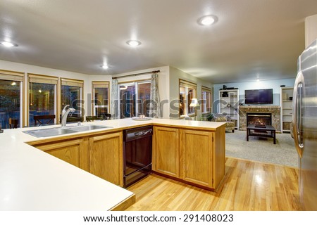 Traditional kitchen with white counters and hardwood floor.