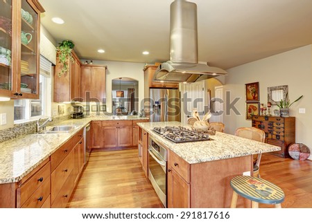 Perfect kitchen with hardwood floor and marble counters.