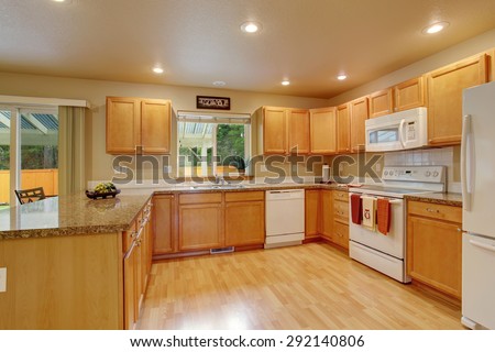 Traditional kitchen with hardwood floor and windows.