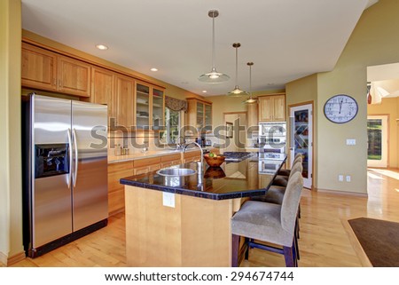 Gorgeous kitchen in perfect traditional home, with large island and light toned hardwood floor.
