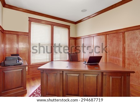 Luxury office room with hardwood floor and nice desk.