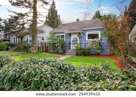 Authentic house with an abundance of greenery and an adorable walkway to white door.