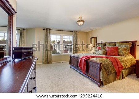 Beautiful master bedroom with carpet, including large vanity with drawers.