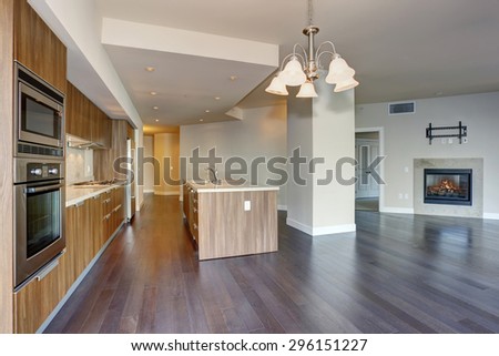 Perfect modern kitchen with hardwood floor and stainless steel fridge.