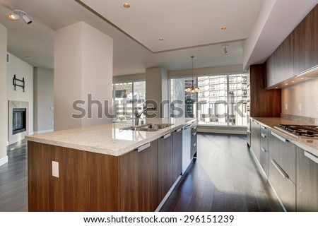 Perfect modern kitchen with hardwood floor and stainless steel fridge.