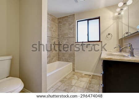 Simple yet elegant bathroom with nice bathtub and tile floor.
