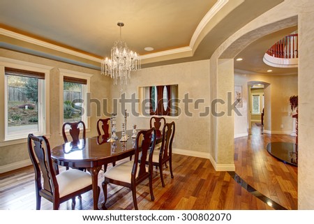 Classical dinning room with beautiful stained wood, and perfect glass chandelier.