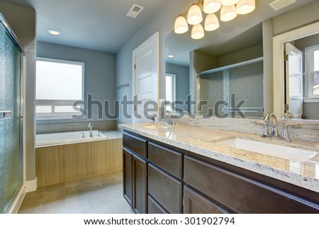 Perfect bathroom with glossy counters, and glass shower.