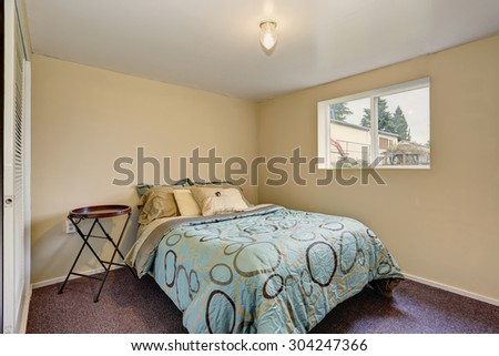 Simple bedroom with decorative bedding and purple interior carpet.