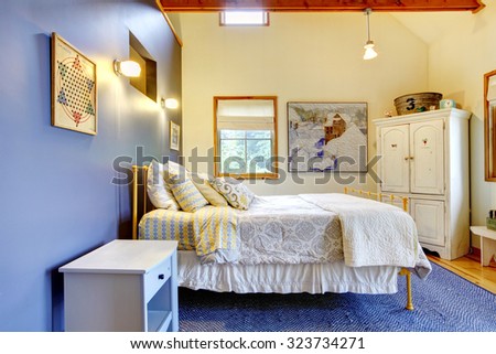 Colorful purple wall bedroom with hardwood floor and blue interior decor.