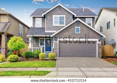 Nice curb appeal of two level house, mocha exterior paint and concrete driveway. View of cozy small porch