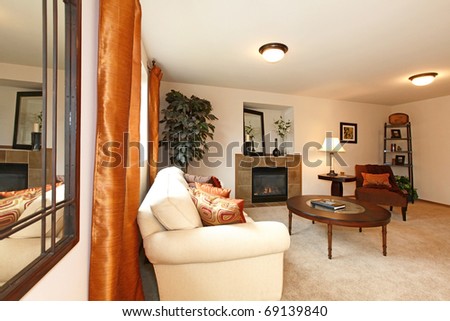 Living room and dining room with beige and orange.