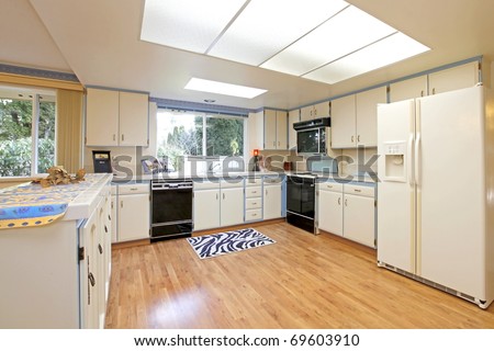 White and blue kitchen with nice hardwood floor