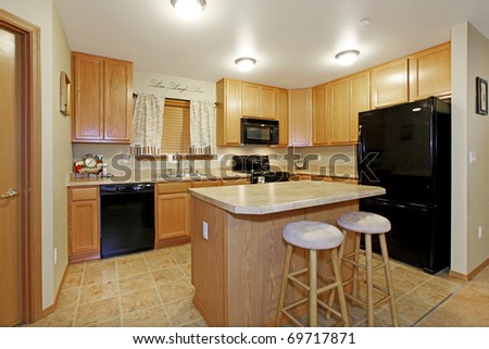 Light color kitchen with black appliances