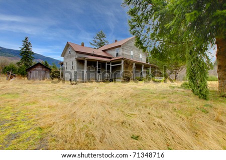 Very old rustic grey house on the country farm land. 113 years old diary farm house near Mt. Rainier in Washington State