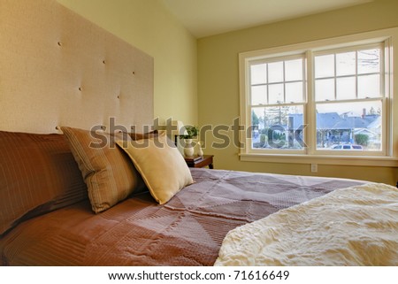 Modern fresh bedroom. Oak floor and browns bedding