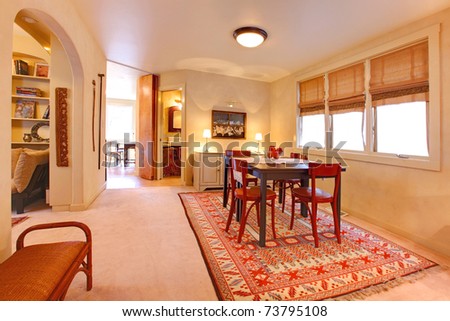 Dining room with folk design, warm yellow and red colors. Old craftsman style home in Seattle.