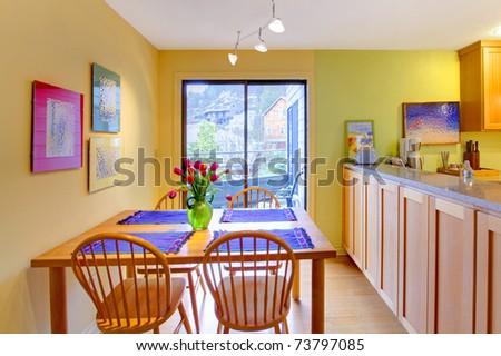 Happy spring dining room and kitchen with tulips and yellow green walls.