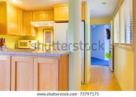 Hallway in an apartment with kitchen and open front door