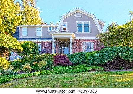 Old craftsman brick house with summer beautiful landscape