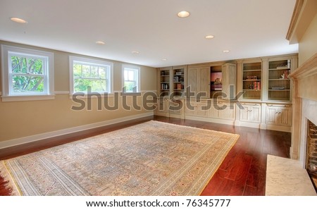 Luxury large room with cherry mahogany hardwood floor and custom made cabinets with entertainment center. Basement in a historical luxury home in Tacoma, WA