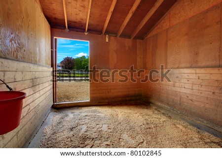 Horse ranch in Washington State, US. Open door at the barn's stable.
