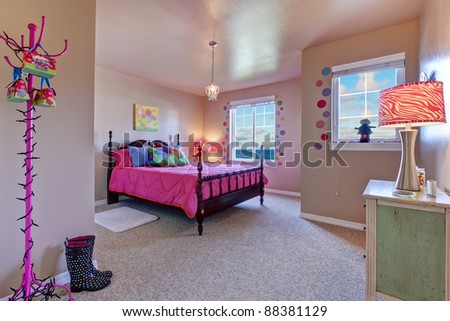 Beautiful large kids beige bedroom with pink bed