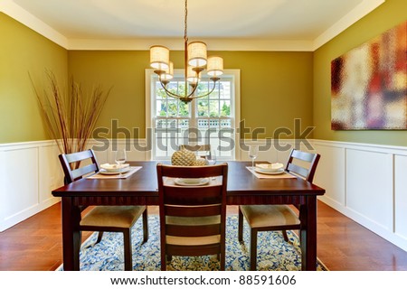 Green craftsman large dining room with cherry floor.