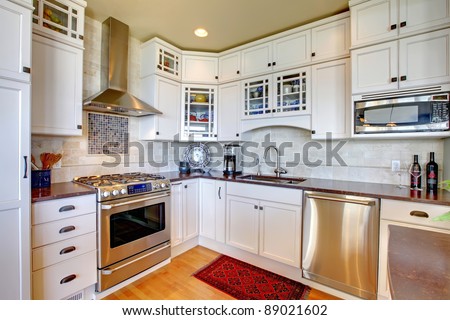 White new luxury kitchen with modern new appliances.