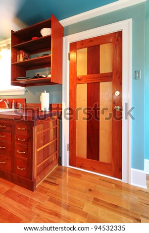 Craftsman build kitchen with wood door and cherry cabinets.