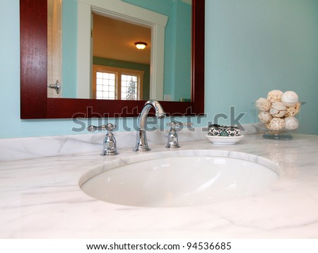 Blue bathroom with white marble sink.
