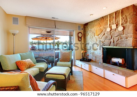 Large fireplace living room with lake view and sofa.