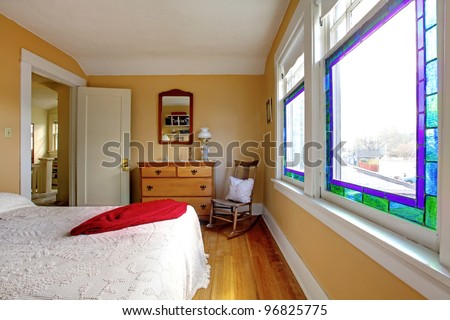 English old bedroom with yellow walls and white bed.