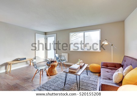 Nicely furnished living room interior after remodeling with wicker details in decor, modern glass chairs. Northwest, USA