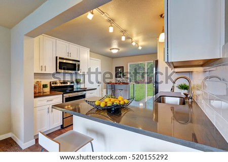 Freshly remodeled kitchen room with white cabinetry and gray counter tops. Northwest, USA