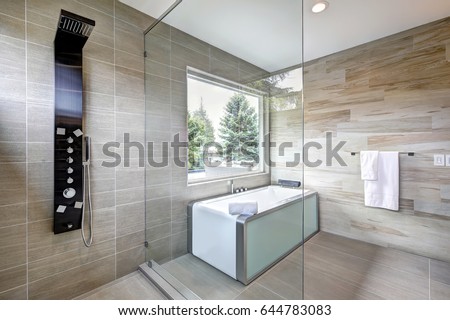 Contemporary master bathroom features modern tub and glass walk-in shower in a new home. Northwest, USA