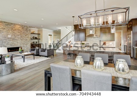 Open plan kitchen equipped with high-end appliances opens to the dining room and the great room with a floor to ceiling stone fireplace. Northwest, USA