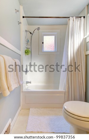 Small blue bathroom with light grey blue and shower curtain Small blue bathroom with light grey blue and shower curtain