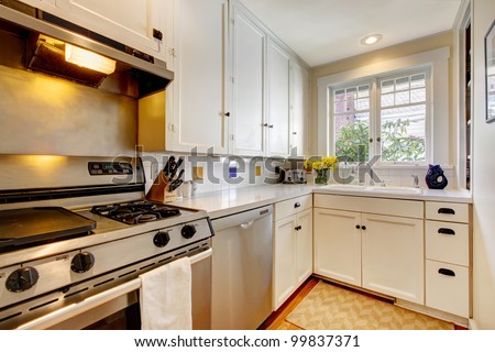 White old kitchen with stainless steal appliances.