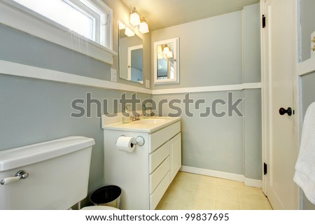 Grey simple bedroom with white cabinet and white door.